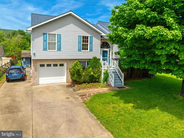 115 Emmitsburg Rd, Thurmont, MD 21788 - split foyer home featuring driveway, brick siding, a front yard, and an attached garage