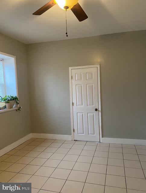 4400 N Franklin St, Philadelphia, PA 19140 - empty room with a ceiling fan, light tile patterned flooring, and baseboards