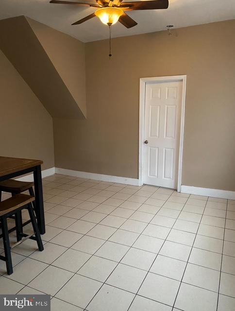 4400 N Franklin St, Philadelphia, PA 19140 - additional living space with a ceiling fan, light tile patterned floors, and baseboards