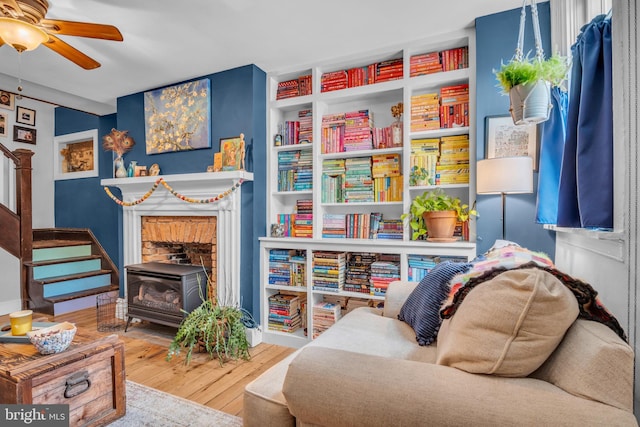 155 E Louther St, Carlisle, PA 17013 - sitting room featuring a wood stove, hardwood / wood-style floors, a ceiling fan, built in features, and baseboards