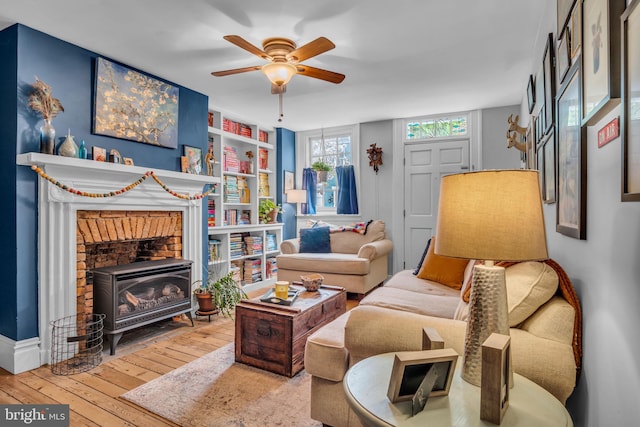 155 E Louther St, Carlisle, PA 17013 - living room featuring hardwood / wood-style flooring, built in shelves, ceiling fan, a wood stove, and baseboards