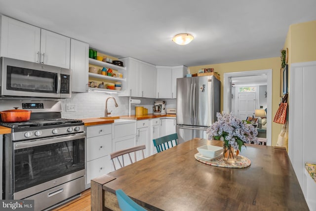 155 E Louther St, Carlisle, PA 17013 - kitchen with appliances with stainless steel finishes, butcher block counters, and white cabinets