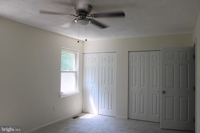 8323 Revelation Ave, Walkersville, MD 21793 - unfurnished bedroom with two closets, carpet floors, a textured ceiling, baseboards, and ceiling fan