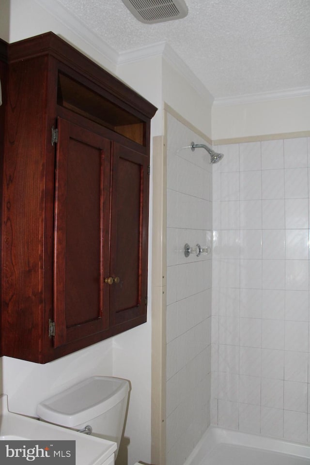 8323 Revelation Ave, Walkersville, MD 21793 - bathroom with a textured ceiling, a shower stall, toilet, and ornamental molding
