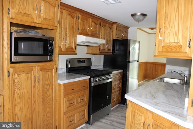 8323 Revelation Ave, Walkersville, MD 21793 - kitchen featuring appliances with stainless steel finishes, range hood, a sink, light countertops, and light wood-style flooring