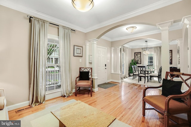 147 Little Quarry Rd, Gaithersburg, MD 20878 - living room with ornate columns, healthy amount of natural light, wood-type flooring, crown molding, and arched walkways