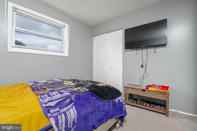 bedroom with a closet, carpet floors, and baseboards