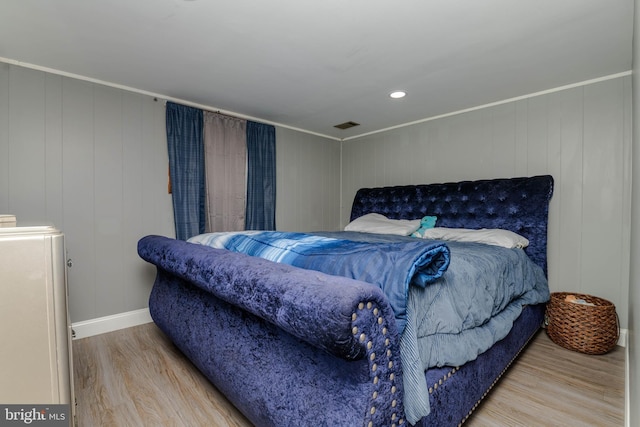 bedroom with wood finished floors, baseboards, and recessed lighting
