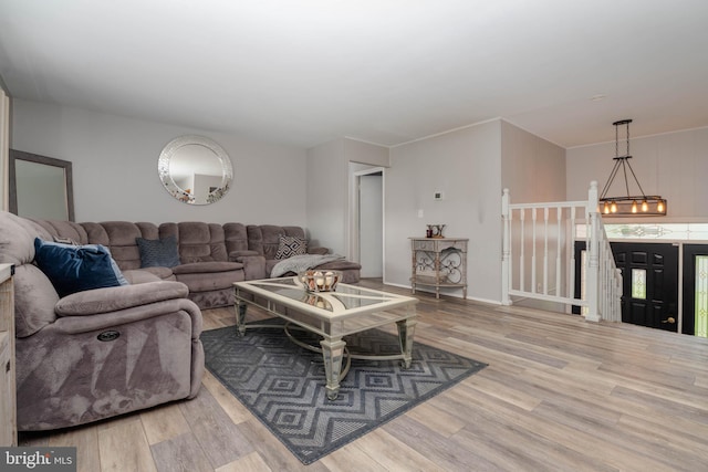 living area featuring wood finished floors and a chandelier