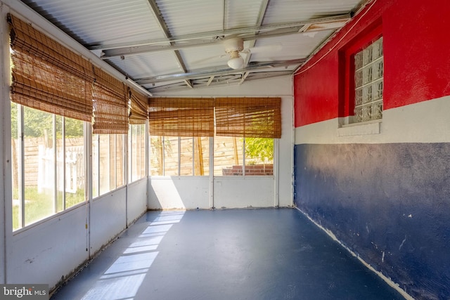 unfurnished sunroom featuring a ceiling fan
