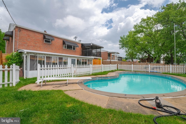 view of swimming pool featuring a sunroom and a diving board