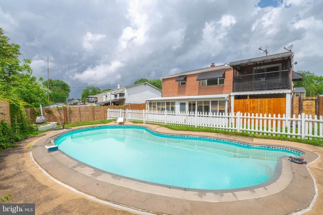 view of swimming pool with a fenced backyard