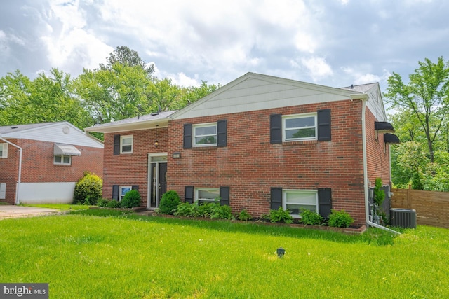 view of front of property with central air condition unit and brick siding