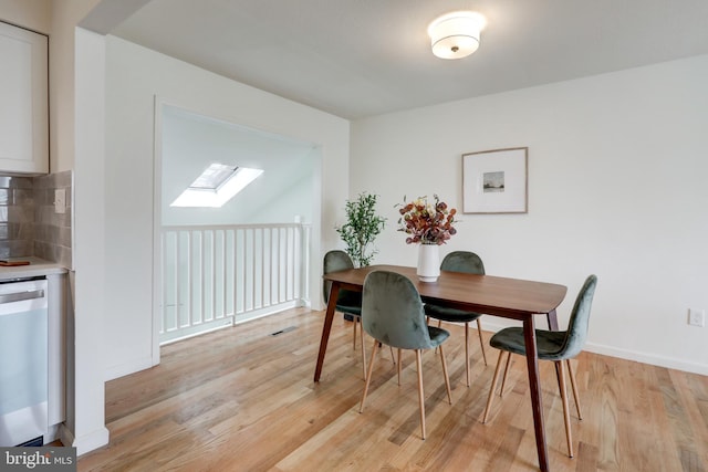 809 N Arch St, Mechanicsburg, PA 17055 - dining space featuring a skylight, light wood-style floors, and baseboards