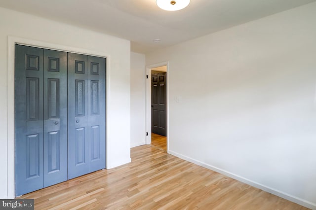 809 N Arch St, Mechanicsburg, PA 17055 - unfurnished bedroom featuring baseboards, light wood finished floors, and a closet
