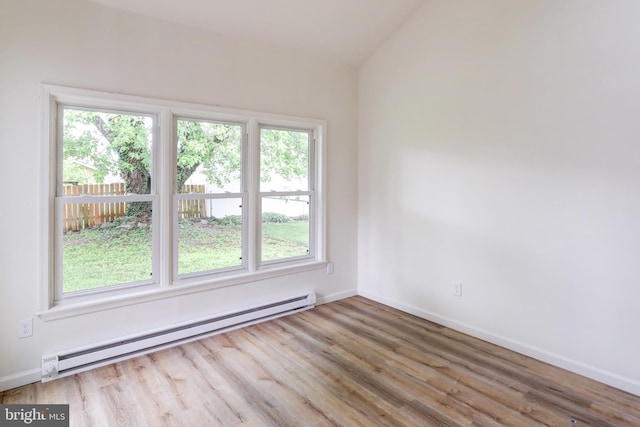 809 N Arch St, Mechanicsburg, PA 17055 - spare room with a baseboard heating unit, wood finished floors, baseboards, and lofted ceiling