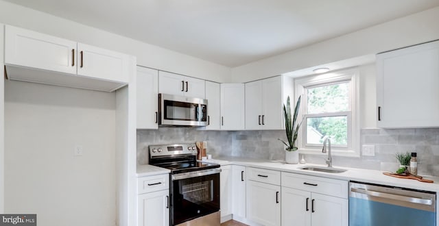 809 N Arch St, Mechanicsburg, PA 17055 - kitchen featuring stainless steel appliances, white cabinets, backsplash, and light countertops