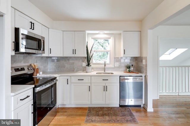 809 N Arch St, Mechanicsburg, PA 17055 - kitchen with stainless steel appliances, a sink, light countertops, and white cabinets