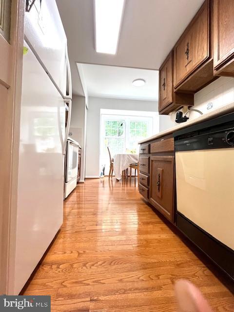 5044 Head Ct, Fairfax, VA 22032 - kitchen with white appliances, light wood-type flooring, and light countertops