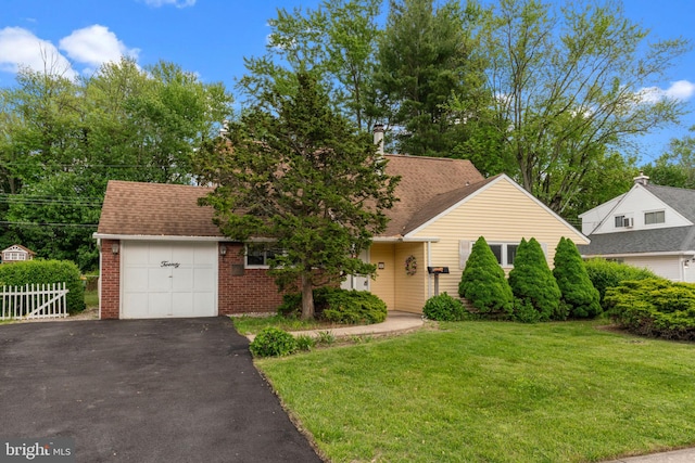 20 Hollow Rd, Levittown, PA 19056 - obstructed view of property featuring driveway, brick siding, and a garage