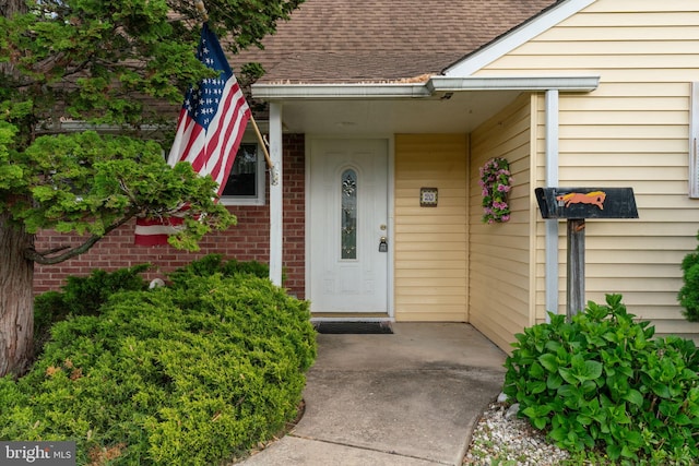 20 Hollow Rd, Levittown, PA 19056 - view of exterior entry with a shingled roof and brick siding