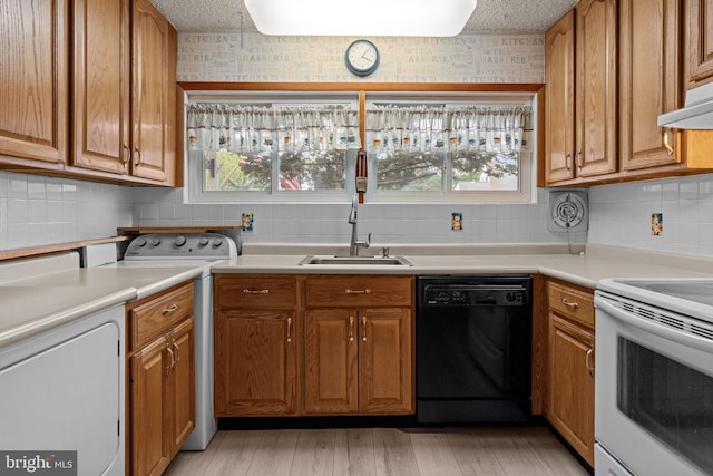 20 Hollow Rd, Levittown, PA 19056 - kitchen with dishwasher, white electric range, a sink, washer / dryer, and tasteful backsplash