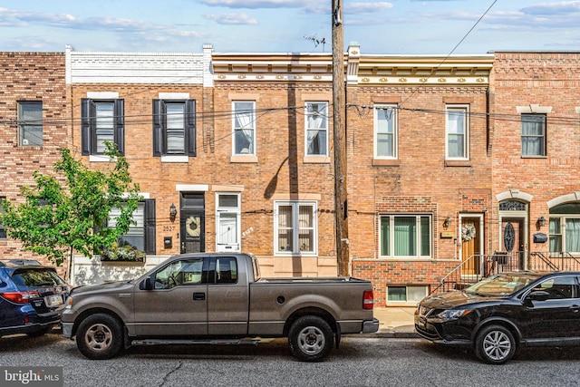 townhome / multi-family property with brick siding