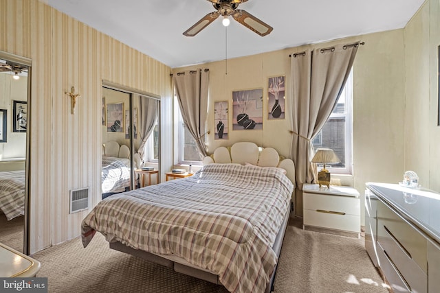 bedroom with carpet, wallpapered walls, and a ceiling fan