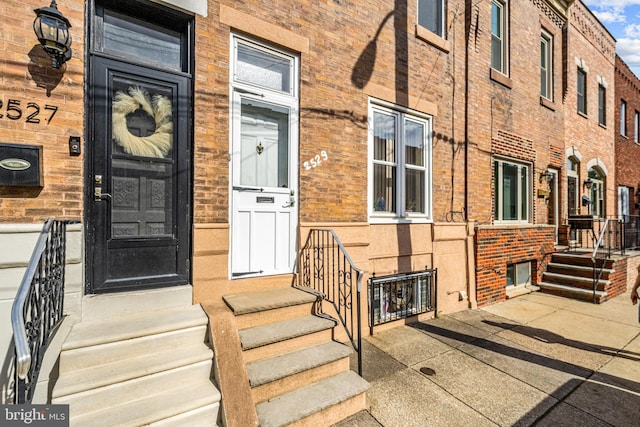 entrance to property with brick siding