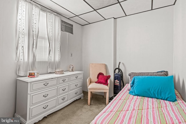 bedroom with light colored carpet and a paneled ceiling