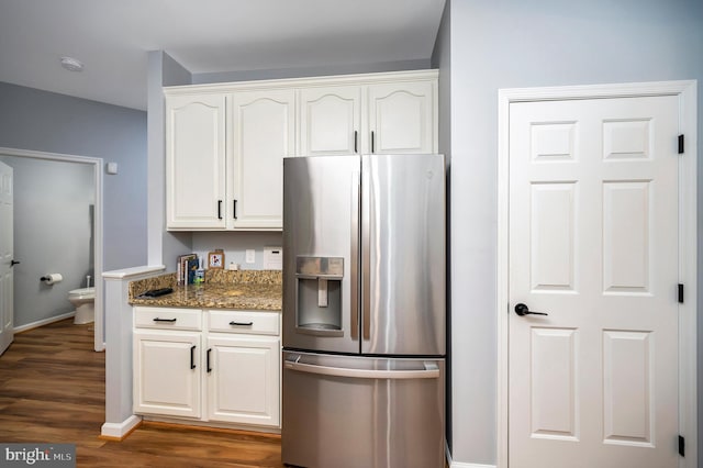 32 Beau Ridge Dr, Stafford, VA 22556 - kitchen with stainless steel fridge, dark wood-type flooring, dark stone counters, white cabinetry, and baseboards