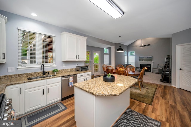 32 Beau Ridge Dr, Stafford, VA 22556 - kitchen featuring appliances with stainless steel finishes, a sink, a lit fireplace, white cabinetry, and wood finished floors