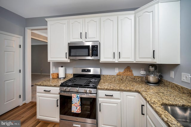 32 Beau Ridge Dr, Stafford, VA 22556 - kitchen with stainless steel appliances, white cabinetry, wood finished floors, and light stone counters