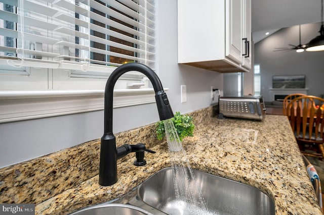 32 Beau Ridge Dr, Stafford, VA 22556 - kitchen view of white cabinetry, a sink, light stone countertops, and ceiling fan
