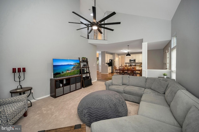 32 Beau Ridge Dr, Stafford, VA 22556 - living area with high vaulted ceiling, light carpet, a ceiling fan, and baseboards