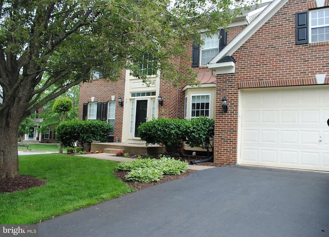 32 Beau Ridge Dr, Stafford, VA 22556 - view of front of house with a garage, brick siding, asphalt driveway, and a front lawn