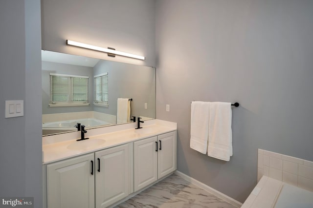 32 Beau Ridge Dr, Stafford, VA 22556 - bathroom with a garden tub, marble look tiles, double vanity, and baseboards