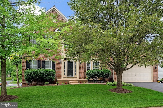 32 Beau Ridge Dr, Stafford, VA 22556 - view of front of home featuring driveway, a front yard, and brick siding