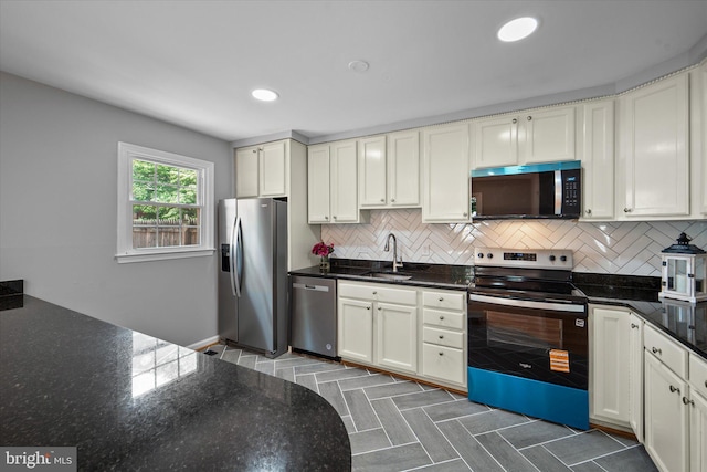 4559 Airlie Way, Annandale, VA 22003 - kitchen featuring stainless steel appliances, a sink, backsplash, dark stone countertops, and recessed lighting