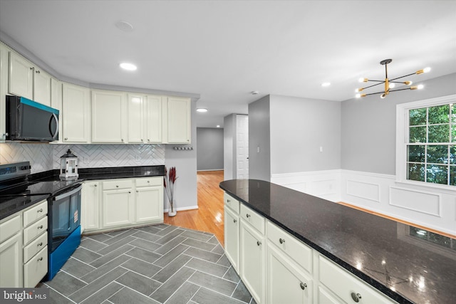4559 Airlie Way, Annandale, VA 22003 - kitchen with electric range, a chandelier, backsplash, dark stone countertops, and recessed lighting