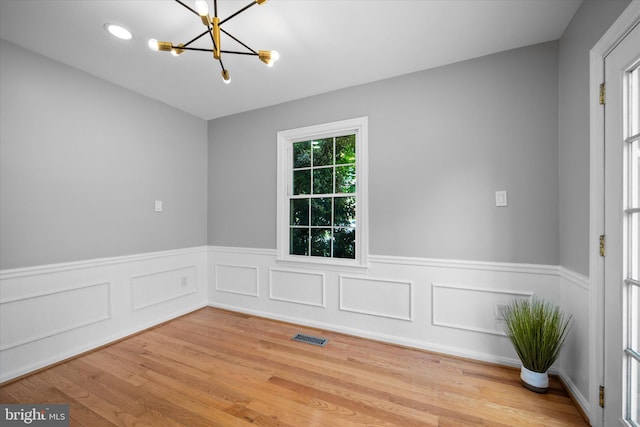4559 Airlie Way, Annandale, VA 22003 - empty room featuring a chandelier, a wainscoted wall, and light wood finished floors