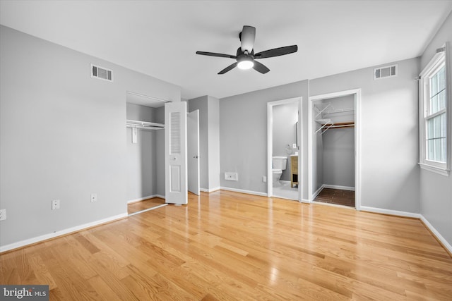 4559 Airlie Way, Annandale, VA 22003 - unfurnished bedroom with wood finished floors, baseboards, ensuite bathroom, ceiling fan, and a walk in closet