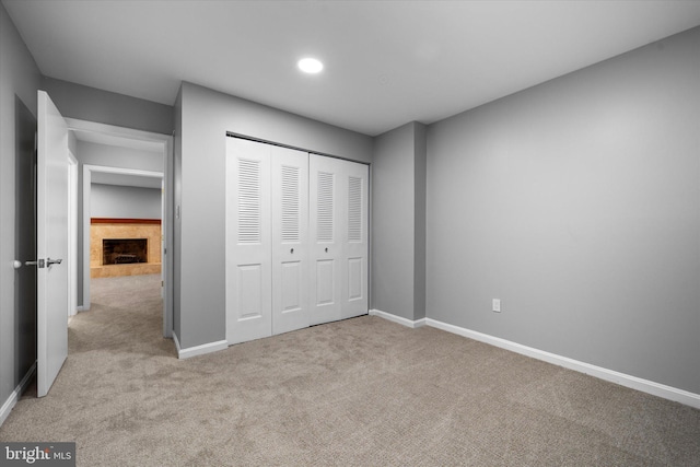 4559 Airlie Way, Annandale, VA 22003 - unfurnished bedroom with carpet, baseboards, a closet, a tile fireplace, and recessed lighting