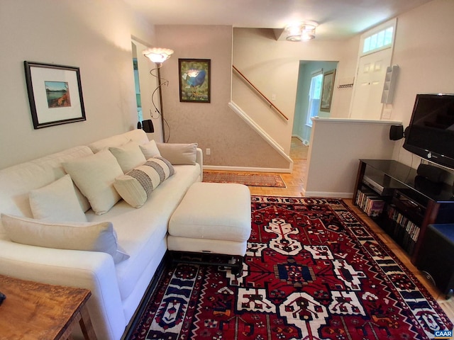 living area with stairs and baseboards