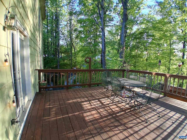 wooden deck with outdoor dining area
