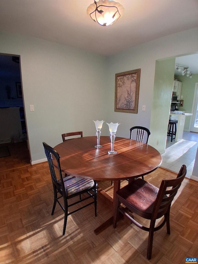 dining area featuring baseboards