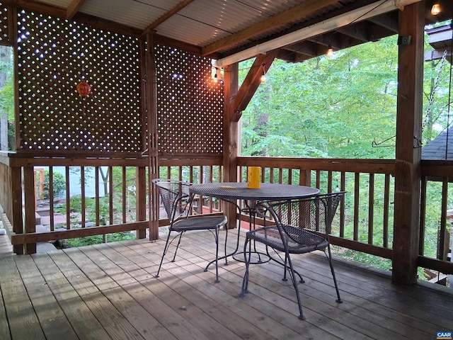 wooden terrace featuring outdoor dining area