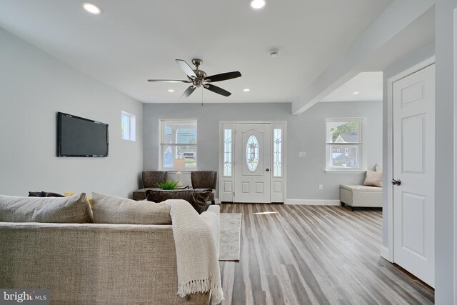 living area with recessed lighting, wood finished floors, baseboards, and a ceiling fan