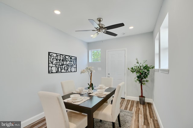 dining room with light wood-style floors, ceiling fan, baseboards, and recessed lighting