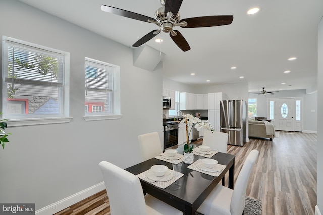 dining area featuring ceiling fan, baseboards, light wood-style floors, and recessed lighting